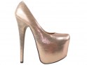 Golden high heels pins on the platform - 1