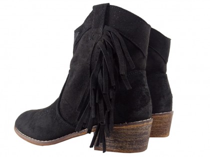 Black suede women's boots on a brick - 2