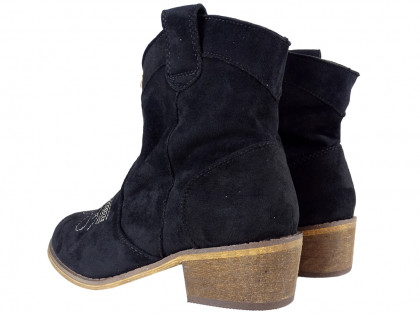 Black suede women's boots on a brick - 2
