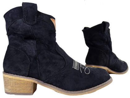 Black suede women's boots on a brick - 3