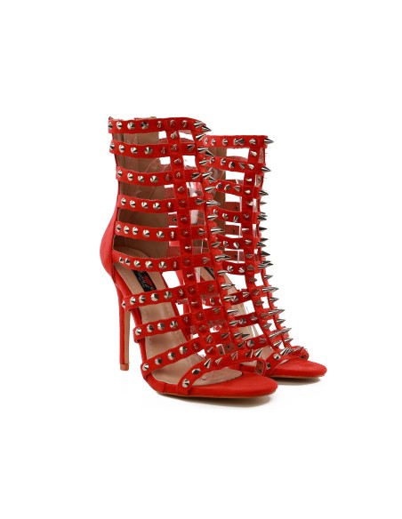 Red gladiator sandals with stiletto heels, spikes, and studs