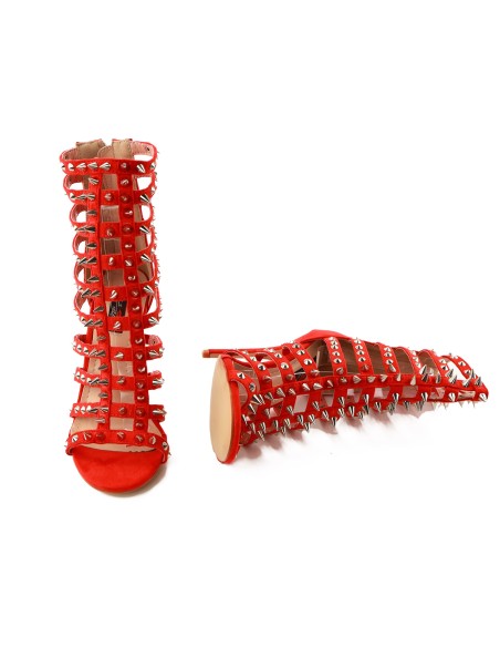 Red gladiator sandals with stiletto heels, spikes, and studs